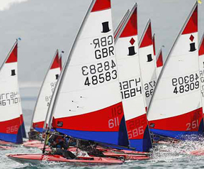 An image showing multiple dinghies racing on the water.