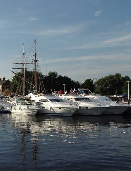 Motor yachts on river pontoon