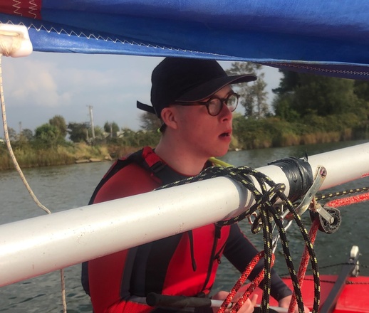 Alex, sailing his boat, concentrating hard