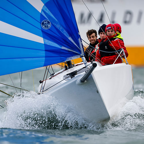 dynamic shot of young people sailinga keelboat on the open water