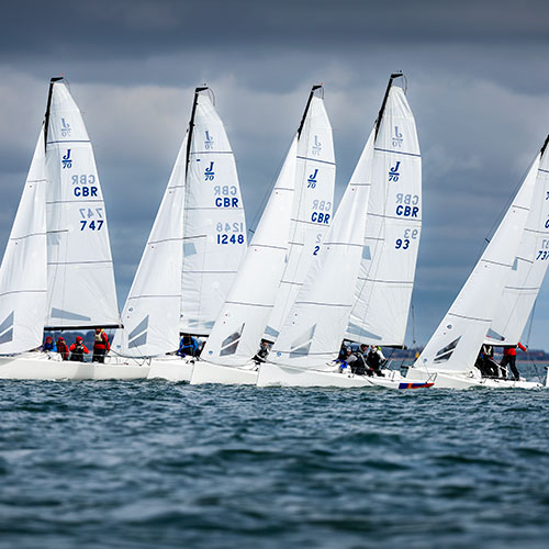 wide shot of keelboats on the open water