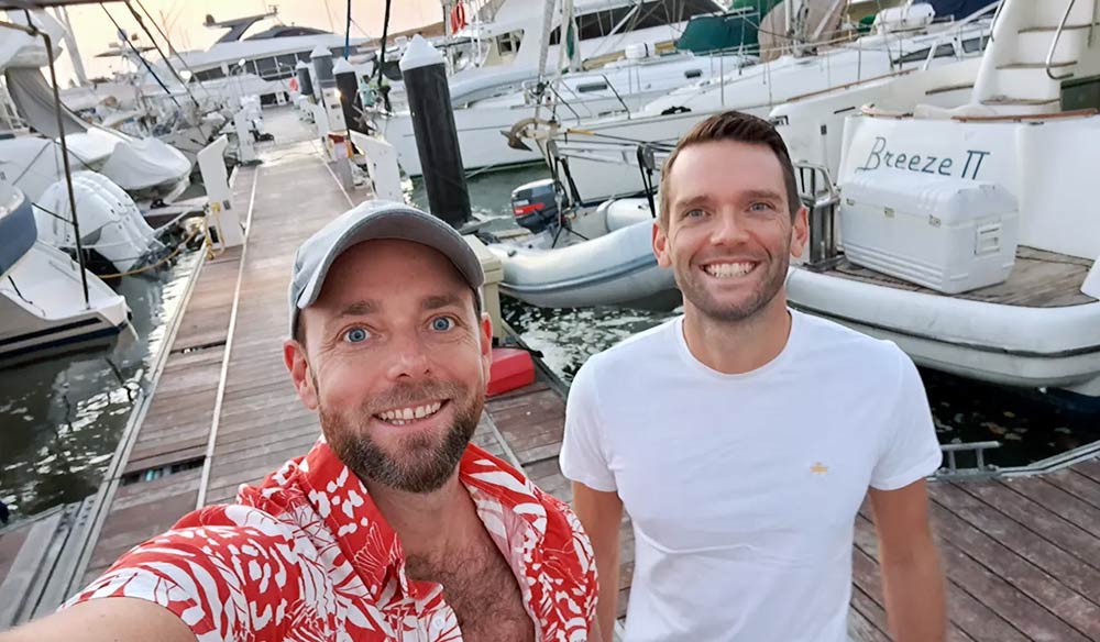 mid shot of tom and peter posing for picture on dockside