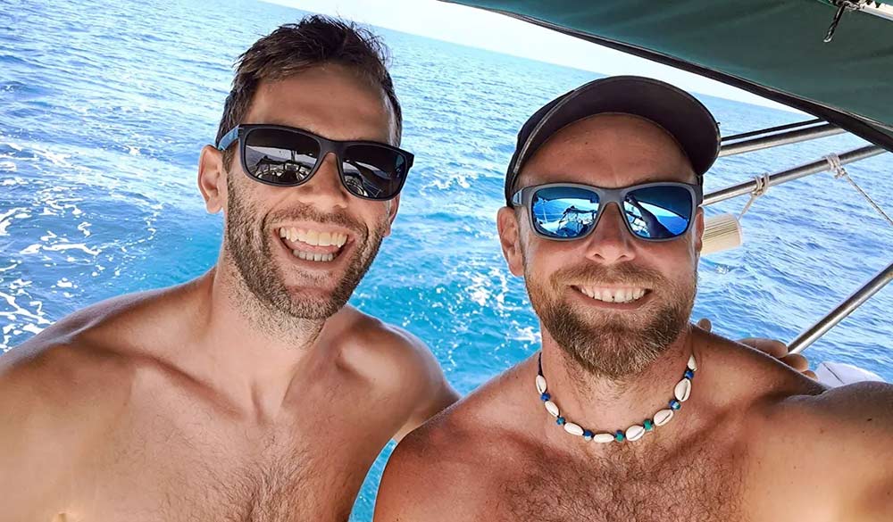 mid shot of tom and peter on sailing yacht on the open sea