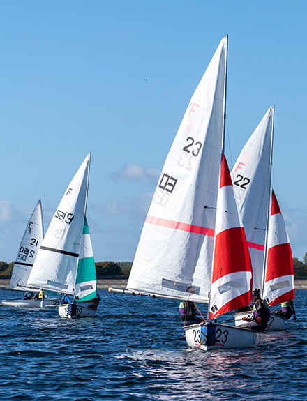 four dinghies racing