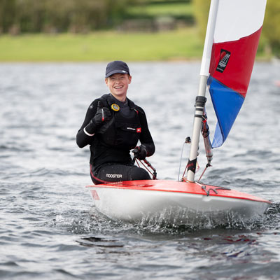 posed shot of dinghy sailor on a lake