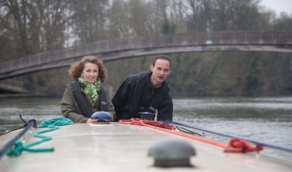 Two people on a canal boat in the winter