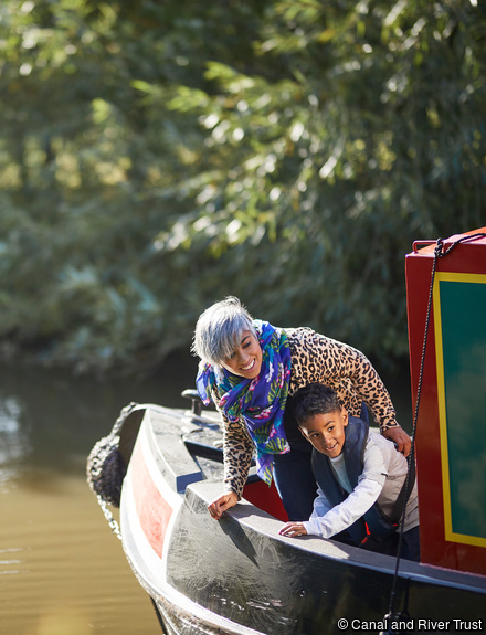 Woman and child at the bow on canal barge on the inland waterways