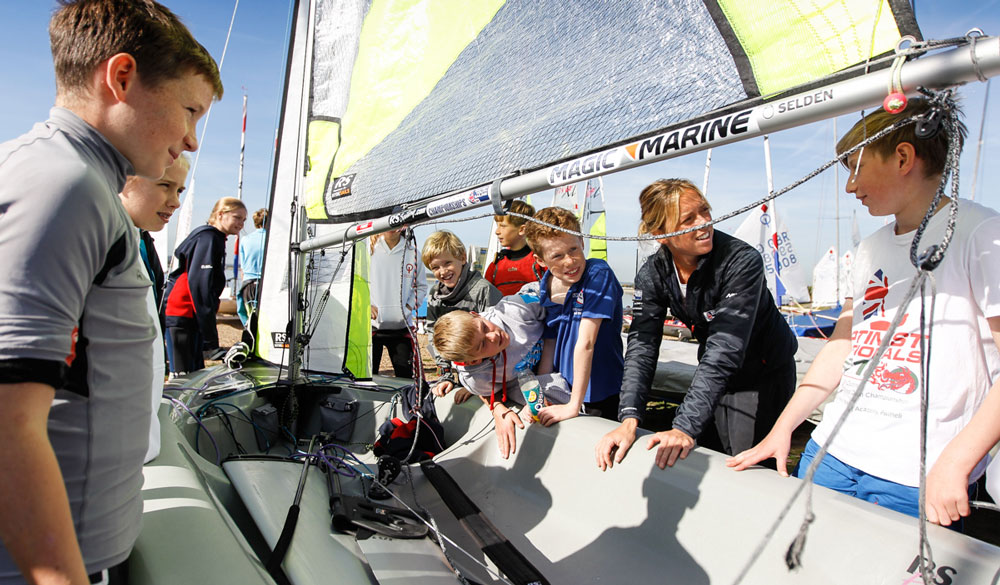 Amy taling to another group of children about her dinghy