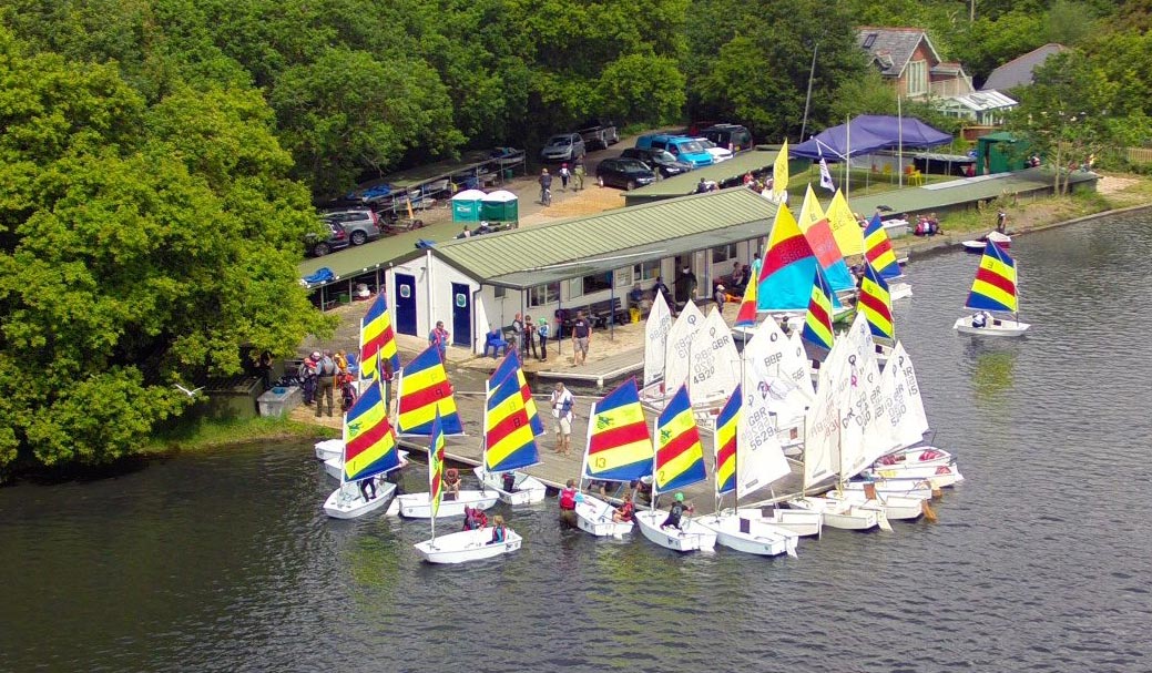 geographical shot of a large fleet of dinghies outside a sailing club next the water